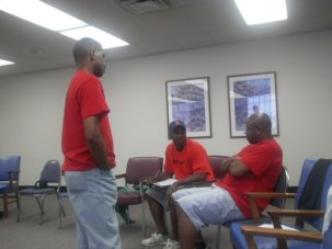 RAGE members David, Emmanuel, and Antoine speaking to the youth from Englewood